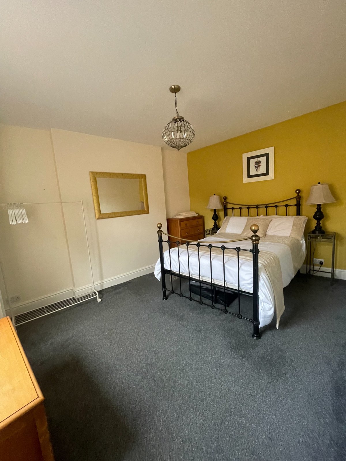 Bedroom with yellow feature wall